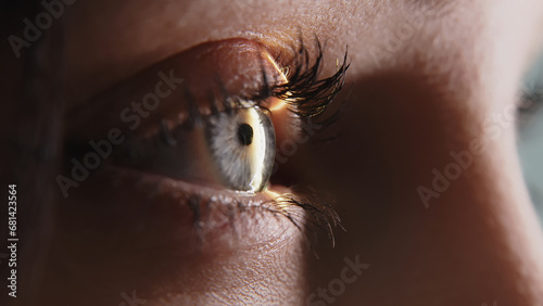 Close-up of a young woman having her vision tested on an ophthalmology diagnostic vision testing equipment. Professional ophthalmological apparatus.