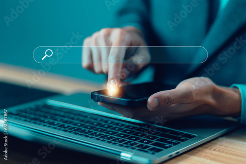 businessman using a laptop and phone show search bar. concept of a website to find a job and career on the Internet, keyword search engines, tool digital online, web browser information optimization