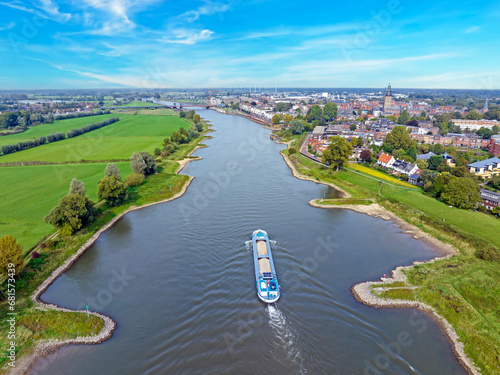 Cargo ship cruising on the river IJssel near Zutphen in the Netherlands