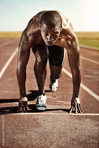 Portrait, man and ready for race, track and field with practice for competition. Olympics, male runner or athlete with determination on face for sprint, performance or sport by commitment for fitness