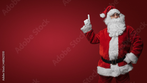 Surprised Santa Claus gesturing with both hands, expressing holiday excitement