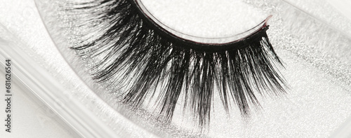 Black long false eyelashes close-up on white background. Self-adhesive eyelashes, eyelash extensions, mascara effect.