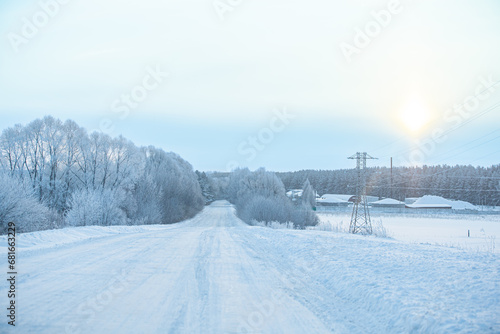 Winter highway past rural landscapes. Ice Road