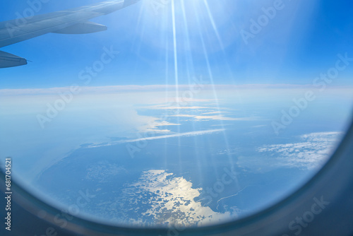 Aerial view of the Astrakhan region, Russia out of focus seen from an airplane with wing in front. Sun rays, glare.