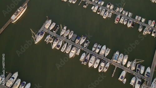 Sunrise at the marina. Boats in the estuary with the sea in the background. Aerial top view from drone with many boats of different types. El Rompido. Huelva. Andalusia. Spain.