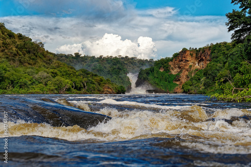 Murchison Falls National Park in Uganda, beautiful water falls on the river Victoria Nile, rainbow above the Uhuru falls and Kabarega falls waterfall in Africa