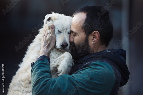 Man holding and hugging dog in shelter