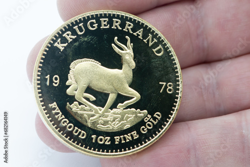A man holds a 1978 Krugerrand 1oz gold coin