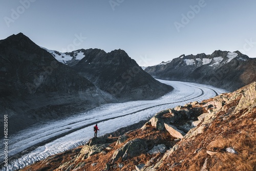 Scenic view of a hiker at sunset on the Aletsch glacier in Wallis, Switzerland