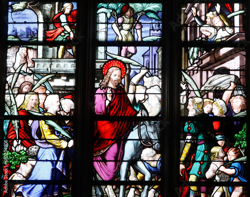 Sainte Croix (Holy Cross) church, Bernay, Eure, France. Stained glass. Palm sunday, Jesus entering Jerusalem on a donkey.