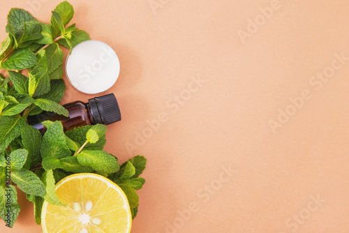 Spa background - essential oil bottle, tea candy, bunch of mint leaves