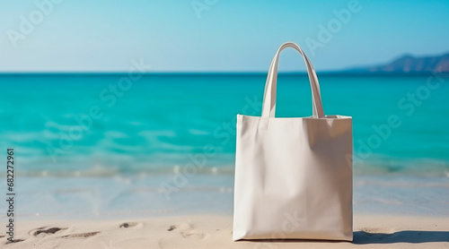 Textile blank eco bag on resort sea beach background. Shopping bag template space for branding and your print