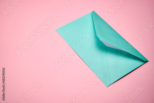 Blue love letter on a pink background.