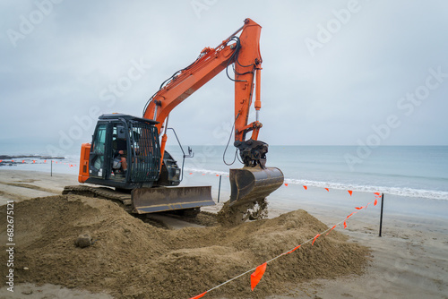Bulldozer at work on a sandy beach.