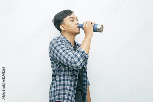 Portrait Asian Indonesian man showing drinking water from tumbler bottle
