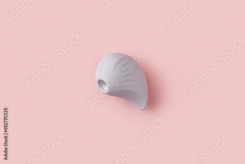 Purple clitoral vibrator on the peach pink background. Sex toys for adults. Flat lay, top view