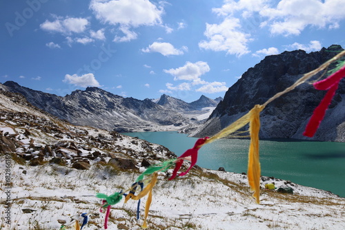 Ala-köl mountain lake with fresh snow during summer in Tian Shan mountains, Karakol, Kyrgyzstan