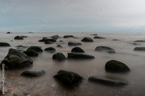 Enigmatic Waters: Long Exposure Unveiling Stones Shrouded in the Sea's Mystic Embrace