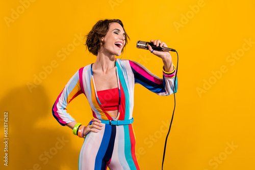 Photo of crazy freak girl wearing old style nostalgia striped costume singing microphone karaoke vocal isolated on yellow color background