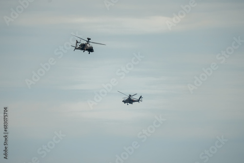 two British army Boeing Apache Attack helicopter gunships AH64E (AH-64E ArmyAir606) in close proximity flight