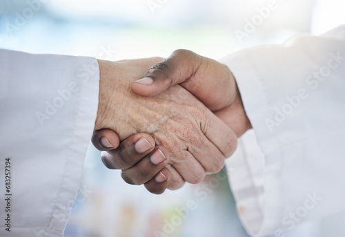 Science, shaking hands and agreement in laboratory for onboarding, deal or gratitude. Welcome, medical research and scientist in handshake for partnership, collaboration or introduction for doctors.