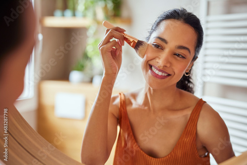 Multiethnic young woman applying make up in the morning
