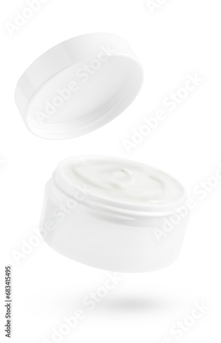 Flying cosmetic cream jar isolated on white background