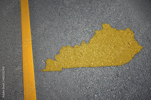 yellow map of kentucky state on asphalt road near yellow line.