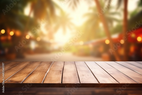 Wooden table top on blurred background with bokeh tropical cafe, coffee shop, bar or restaurant with palm tree