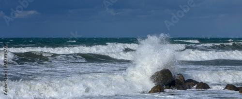 waves break on a stone in the Mediterranean Sea in autumn on the island of Cyprus 1