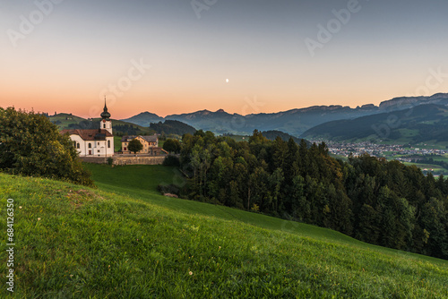 Church in the Appenzell Alps with view to the Alpstein mountains with Hoher Kasten and the village of Appenzell at dusk, Schlatt-Haslen, Canton Appenzell Innerrhoden, Switzerland