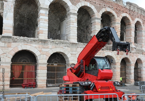 powerful red crane for handling weight loads during the preparation of the events and the ARENA in the background