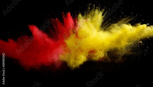 red and yellow colored powder explosions on black background holi paint powder splash in colors of spanish flag