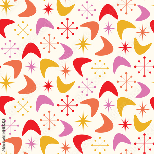 Mid Century Modern Boomerang seamless pattern with atomic retro starbursts in orange, red, pink and yellow. For home decor, textile, wallpaper and fabric.