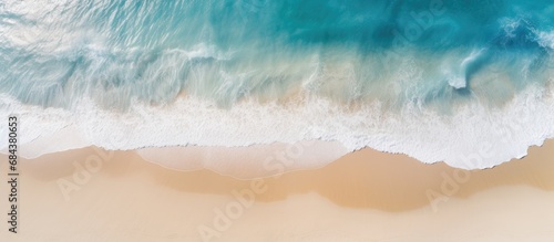 Aerial photography of a beautiful, clean sandy beach and seascape with yellow sand and blue sea, offering copy space.