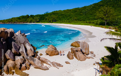 Anse Cocos La Digue Seychelles, a young couple of men and women on a tropical beach during vacation