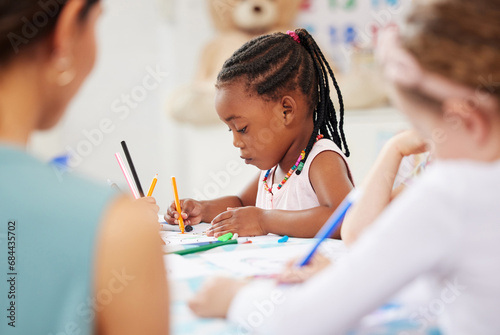 African, kid and pencil for drawing in classroom for learning, education and development of motor skills. Little girl, student on learner with serious, determination and look for creative activity