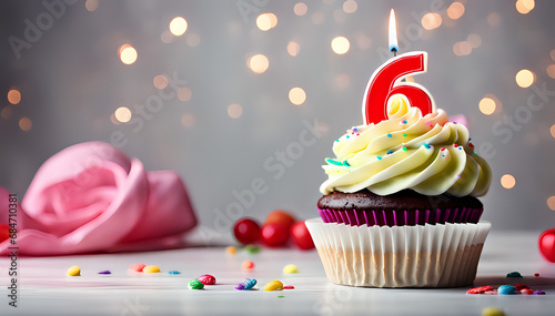 Birthday cupcake with lit birthday candle Number six for six years or sixth anniversary