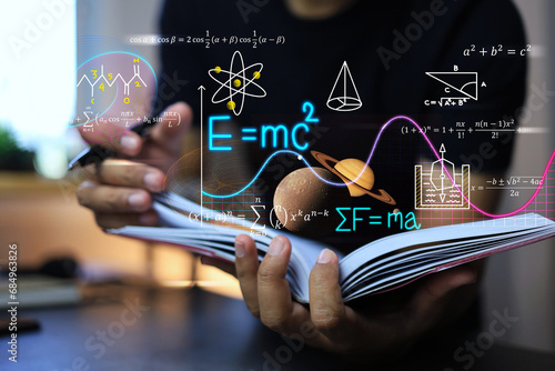 physics and mathematics equation concept with student writing on a notebook about Albert Einstein's calculations of the equations of relativity and Sir Isaac Newton's theory of gravity on note book