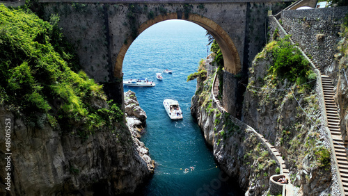 Aerial view of Fjord of Furore, Amalfi coast in Italy . Azure waters embrace the rugged cliff