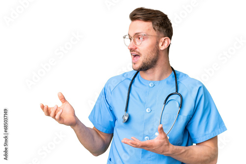 Young nurse man over isolated chroma key background with surprise facial expression