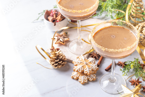Christmas Gingerbread martini cocktail, spicy winter alcohol cocktail with gingerbread syrup, on New Year Xmas decorated background 