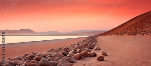 Minimalist sunset photography of red dunes and stones in the Paracas desert Peru copy space image