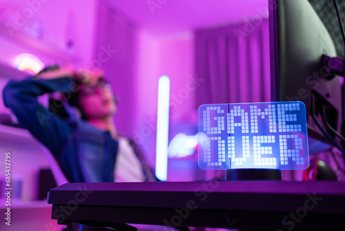 Close up of e-sport man loser gamer play online video game on computer.