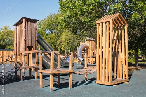 Wooden modern ecological safety children outdoor playground equipment in public park. Nature architecture construction playhouse in city. Children rest and childhood concept. Idea for games on air