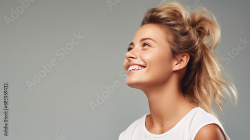a smiling woman looking over into the distance.