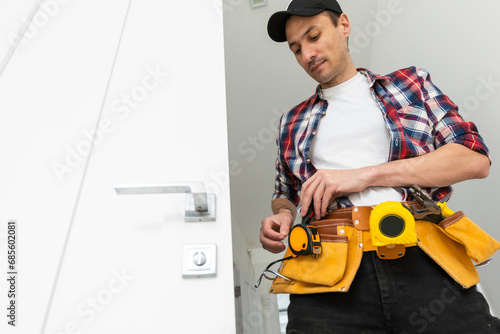 Man installing door architrave repair