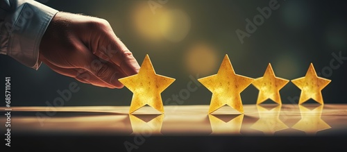 Businessman boosts company s rating with five yellow stars amidst bokeh background Copy space image Place for adding text or design