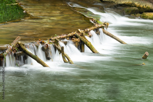 small weir irrigate on a small river in the forest 