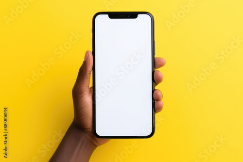 black woman's hand showing big smartphone, white screen empty copy space for advertising banner isolated on yellow background, display mock up